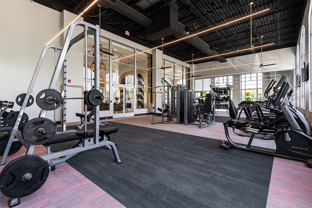 a gym with weights and other exercise equipment in a building