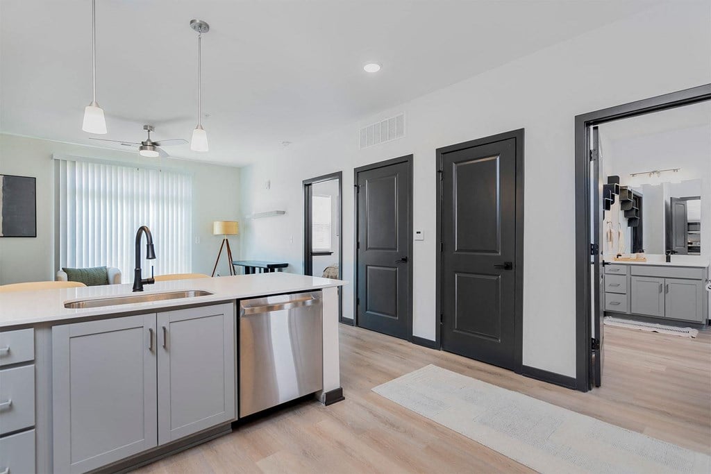 an open kitchen and living room with a sink and a counter