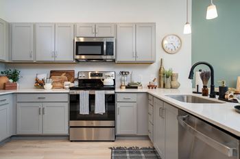 A kitchen with a stove, oven, and microwave.