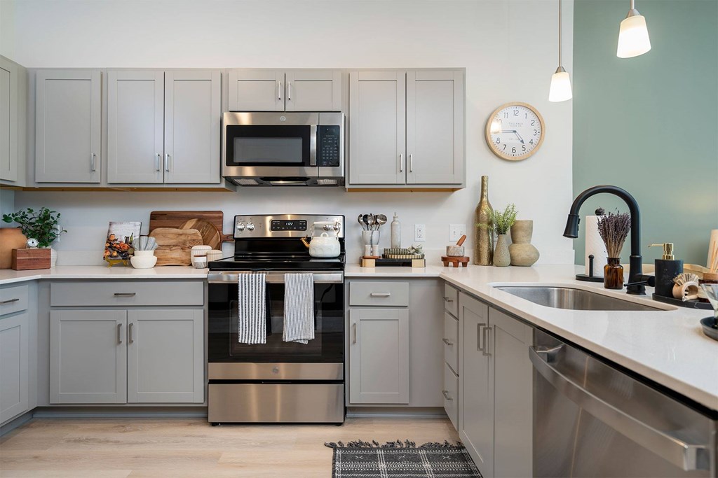 A kitchen with a stove, oven, and microwave.