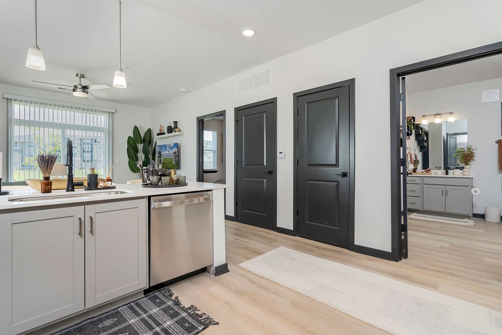 A modern kitchen with wooden floors and a large island.