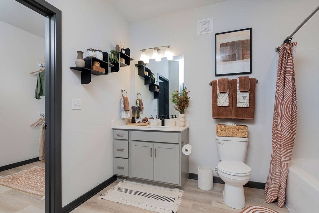 A bathroom with a white toilet and a white bathtub.