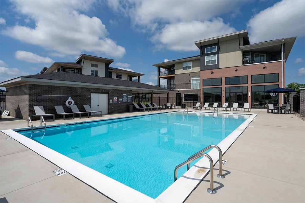 A swimming pool in front of a modern building.
