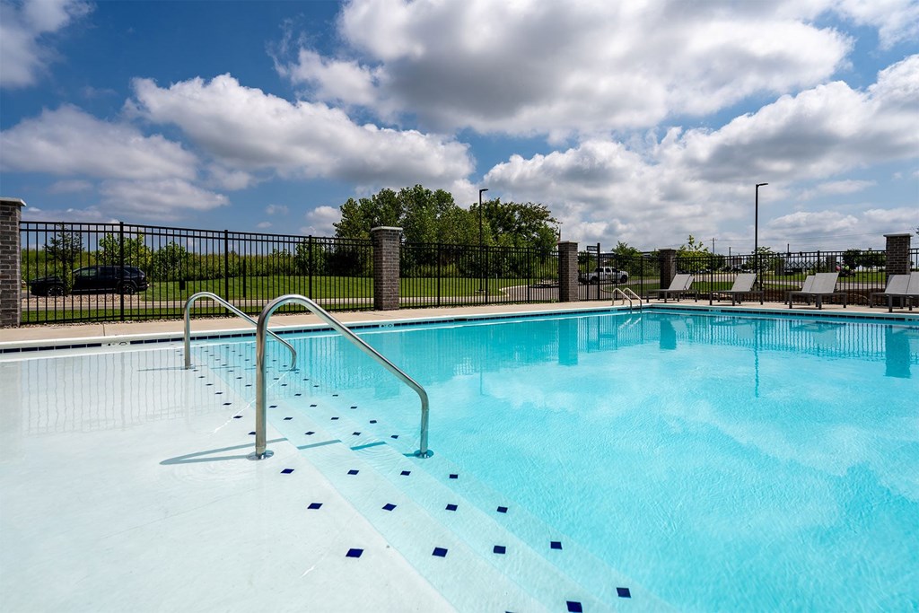 A swimming pool with a metal fence around it.