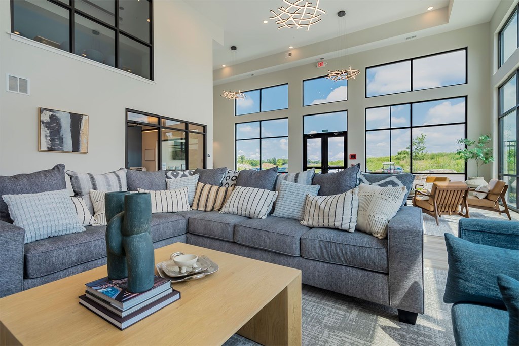 A living room with a grey couch and a wooden coffee table.