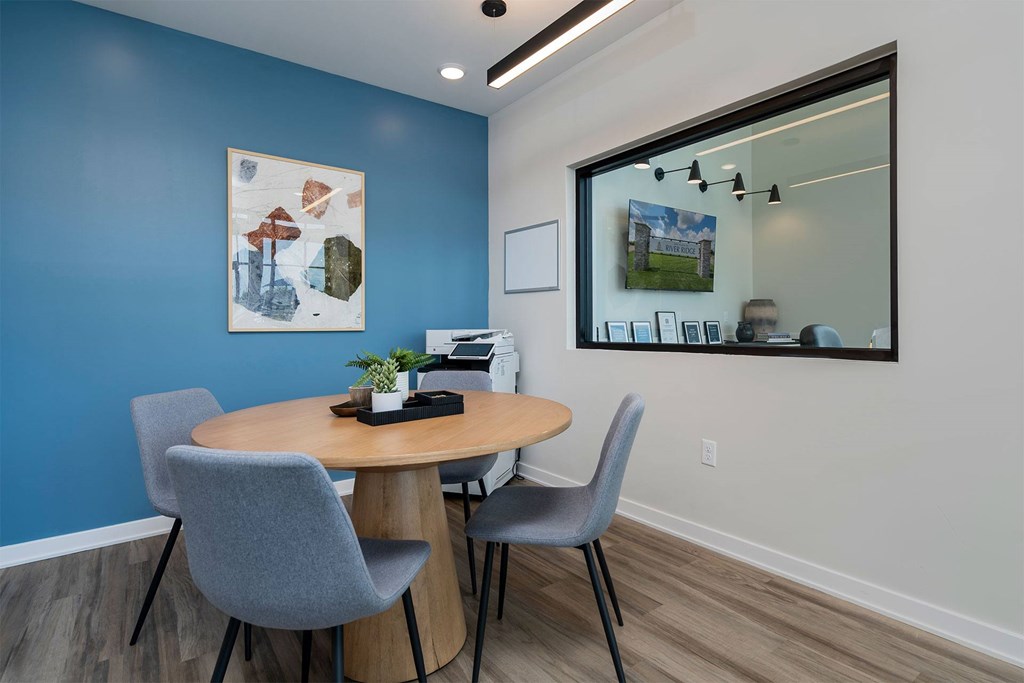 A conference room with a table and chairs.