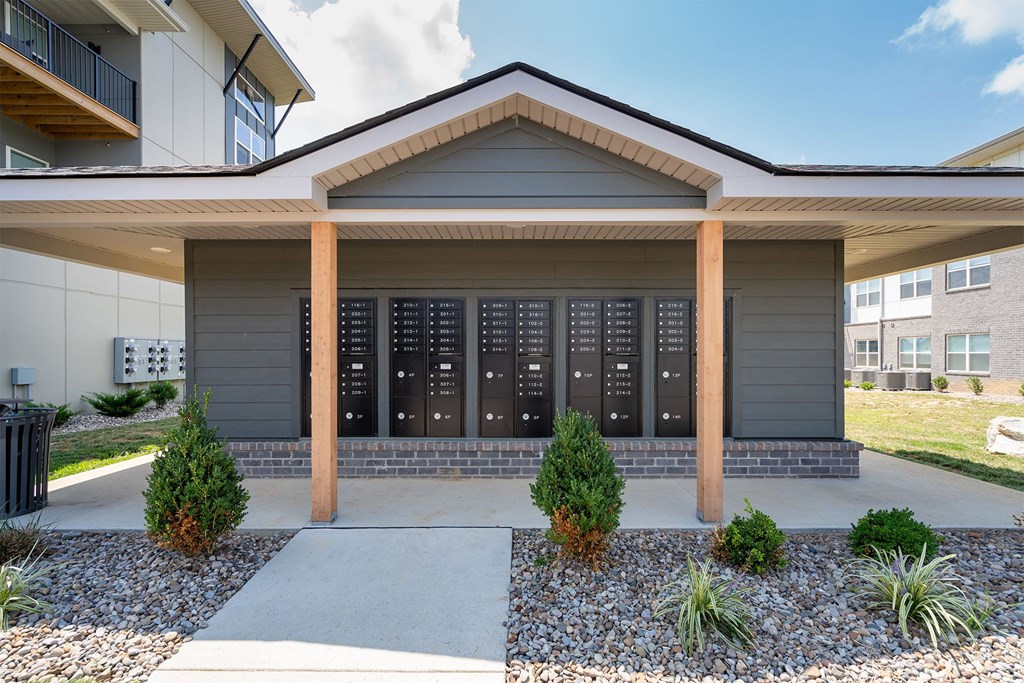 A modern house with a grey front and a black mailbox.