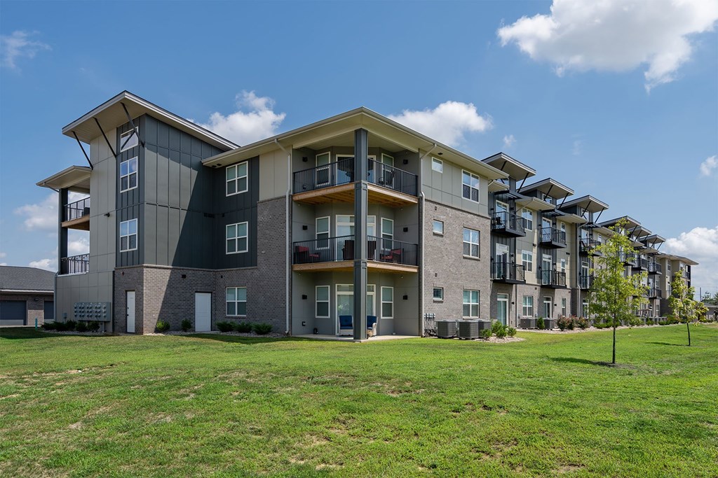 A large apartment complex with multiple balconies and doors.