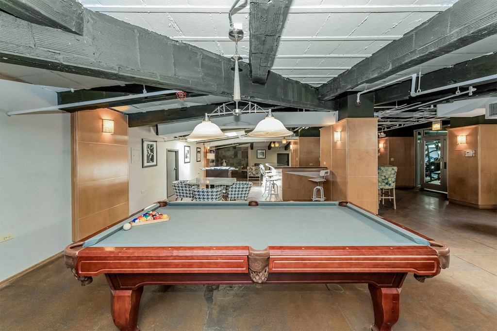 a pool table in the middle of a room in a loft