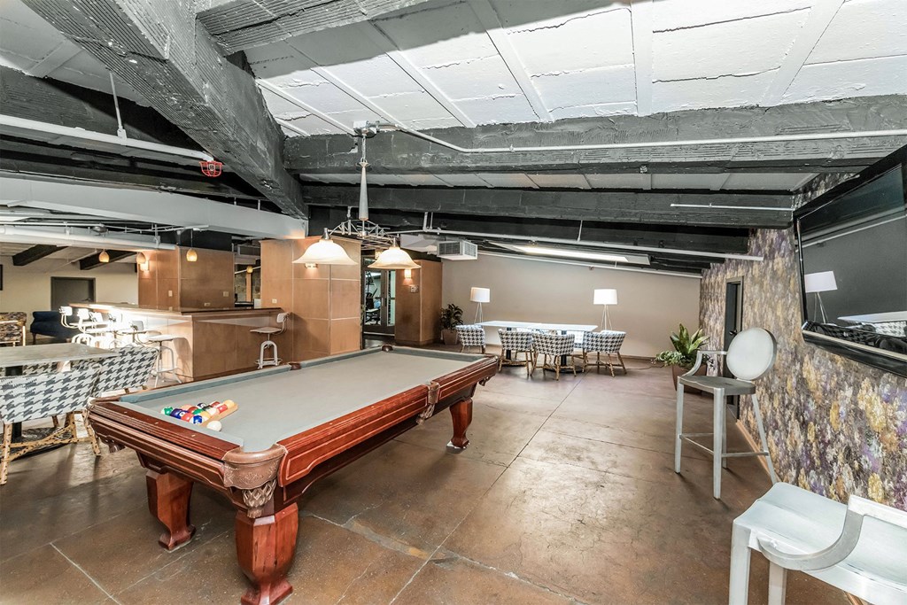 a game room with a pool table and tables