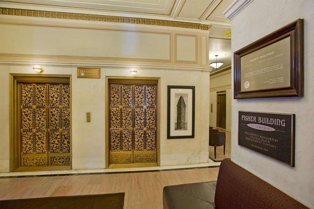 the lobby of a building with two doors and a sign on the wall