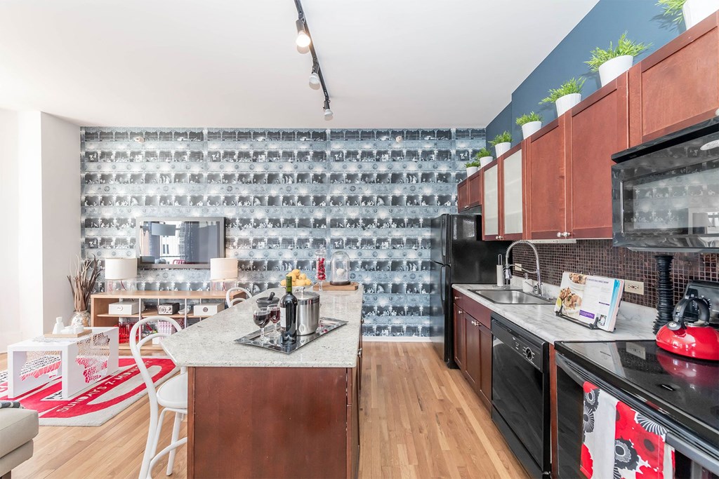 a kitchen with black appliances and a counter top