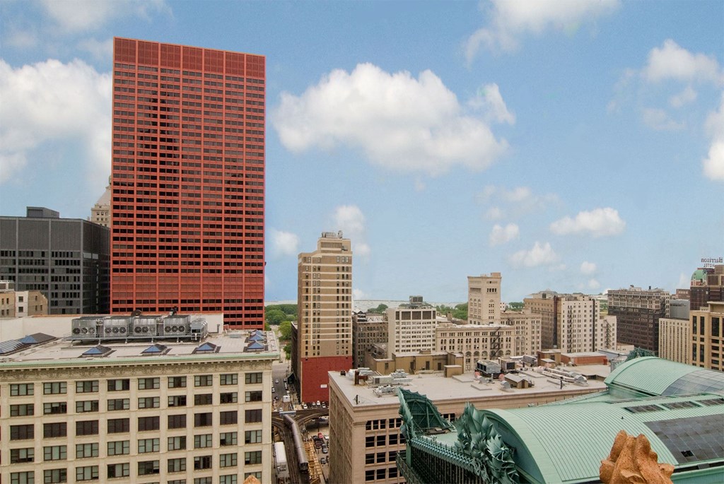 the skyline of the city with a tall red building