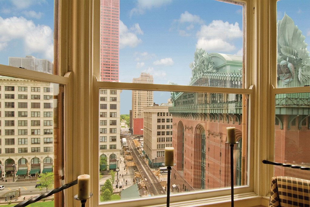 a view of the city from a window of a hotel room