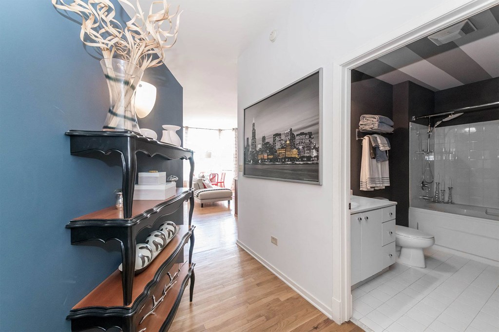 a bathroom with a blue wall and a black cabinet