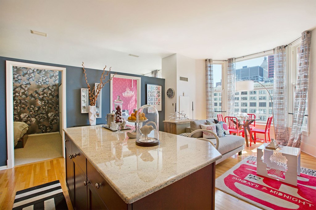 a kitchen with a counter and a living room with a couch