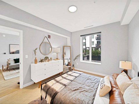 A bedroom with a large bed and a window.
