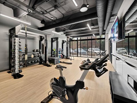 A gym with a stationary bike in the foreground.