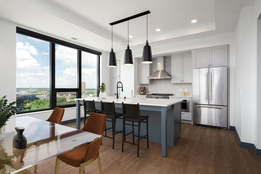 a rendering of a kitchen with a large island and stainless steel appliances