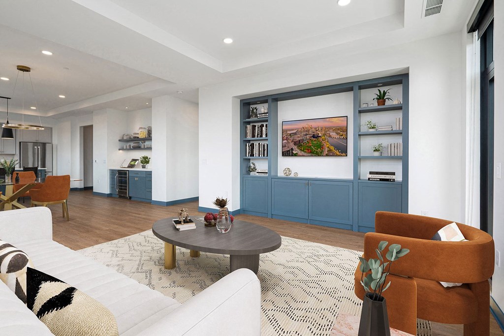 a living room with a white couch and a wooden coffee table
