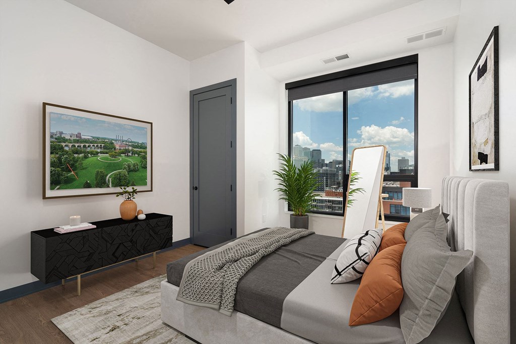 a bedroom with a bed and a large window