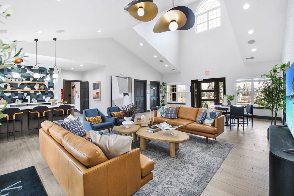 A living room with a brown sofa and a coffee table.