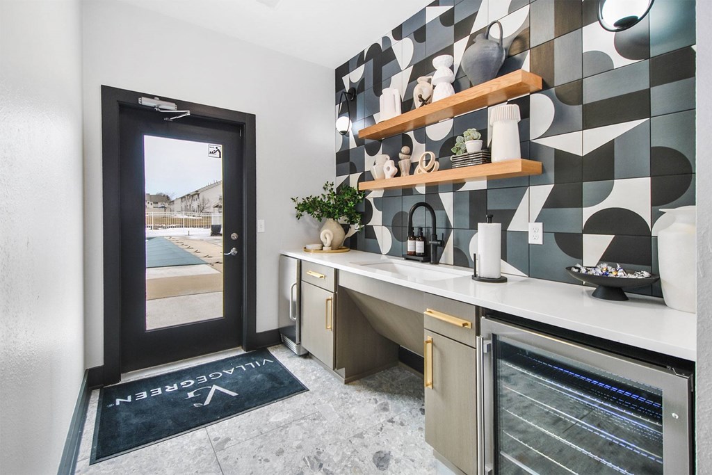 A kitchen with a black mat on the floor that says