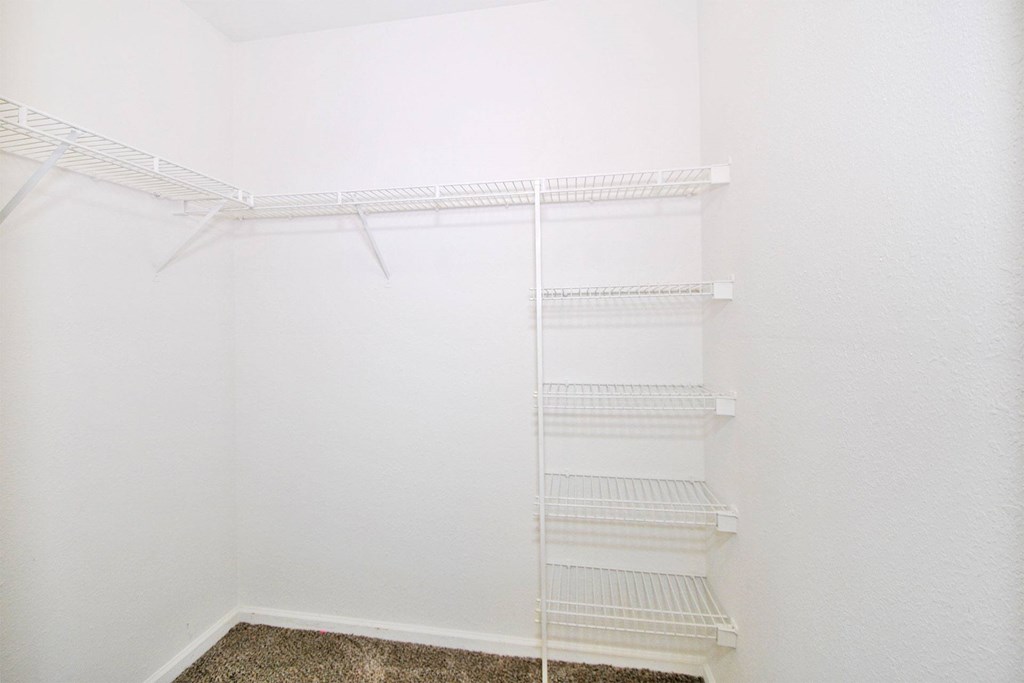 Empty white shelves in a room.