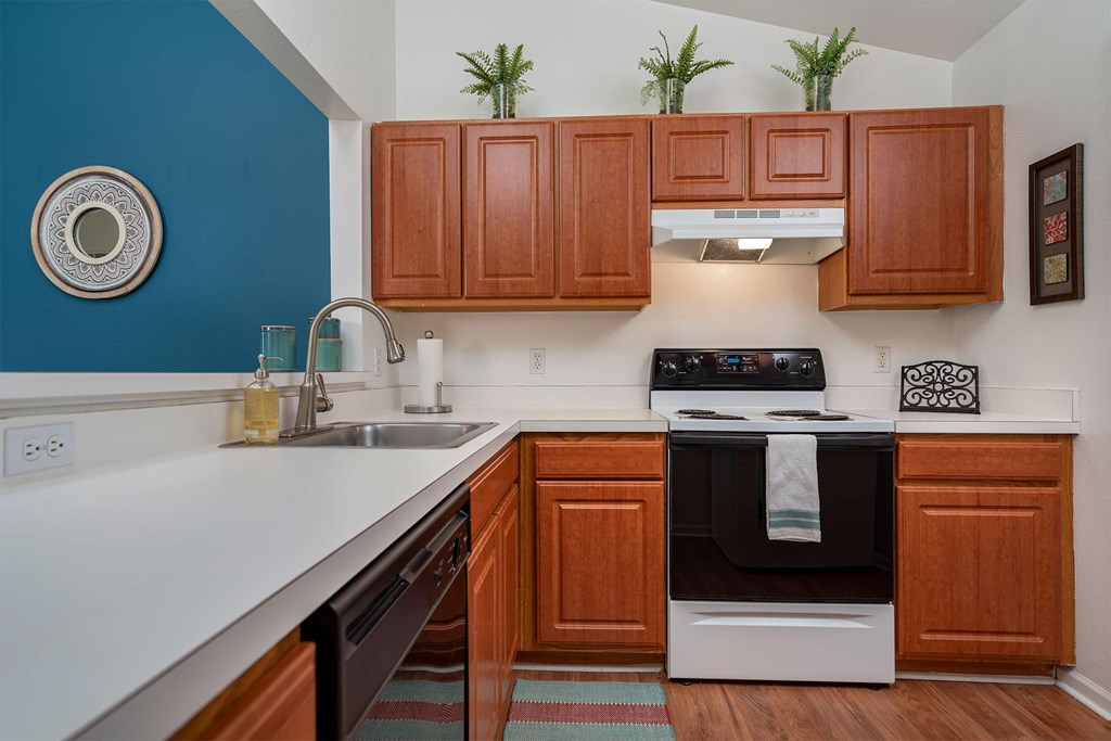 A kitchen with wooden cabinets and a black oven.