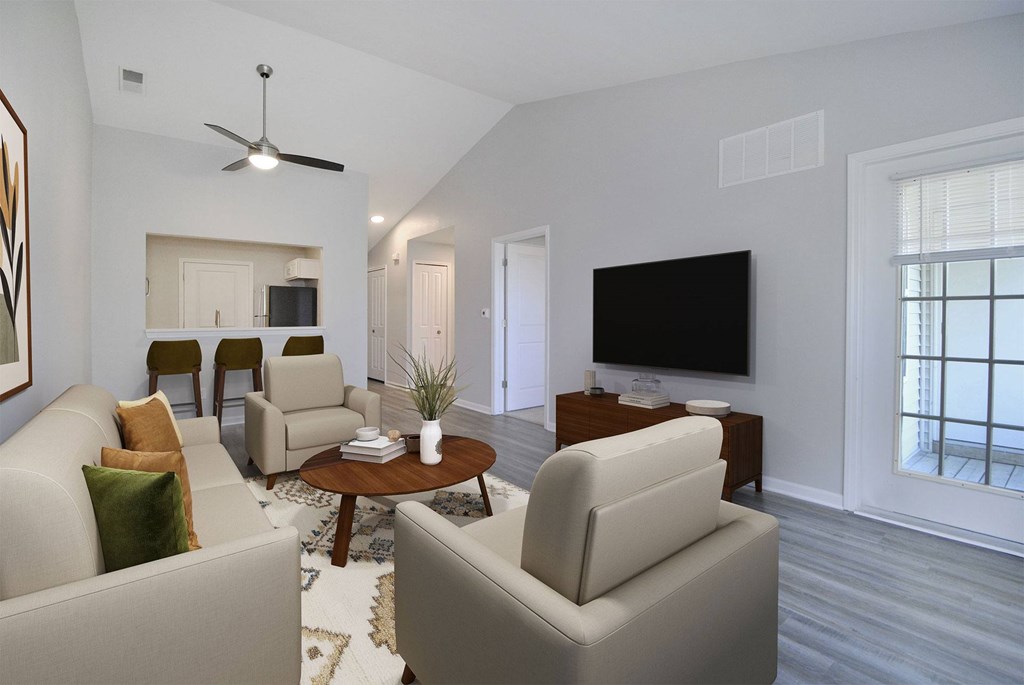 A living room with a white couch and a television.