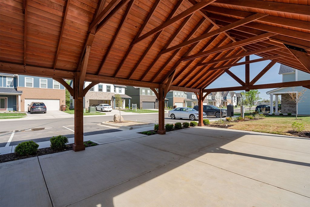 A wooden covered walkway with a concrete floor.