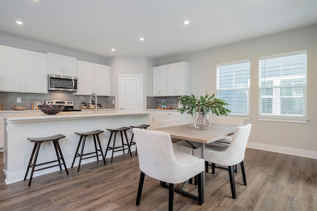 a kitchen and dining room with a table and chairs