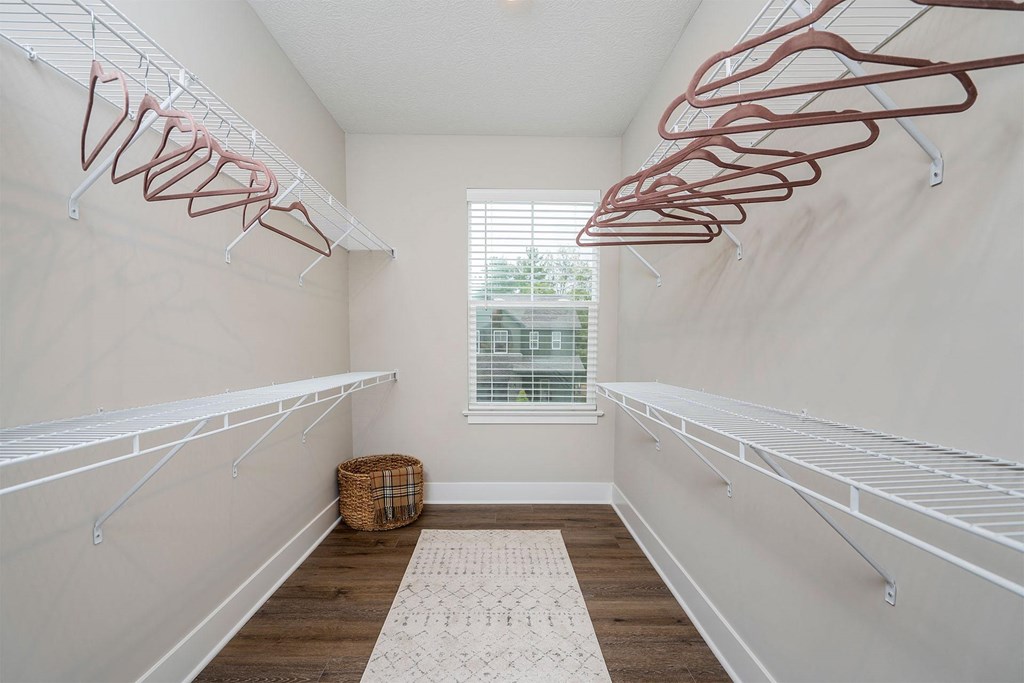 large walk in closet with two rows of shelves