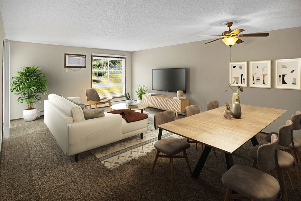 A living room with a white couch, a wooden table, and a television.