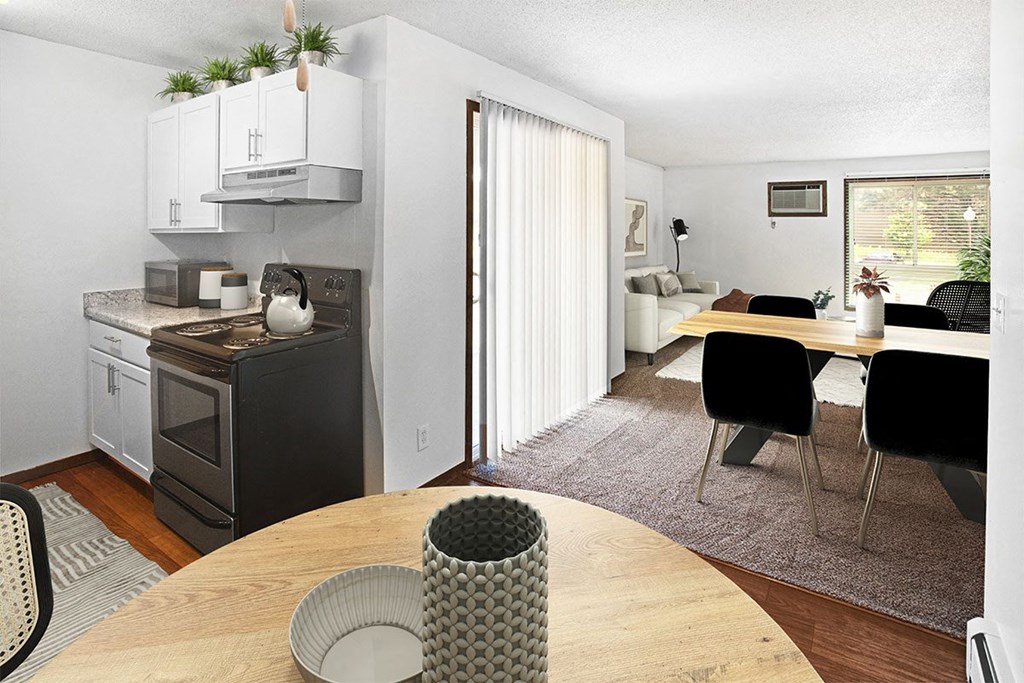 A modern kitchen with a dining table and chairs.