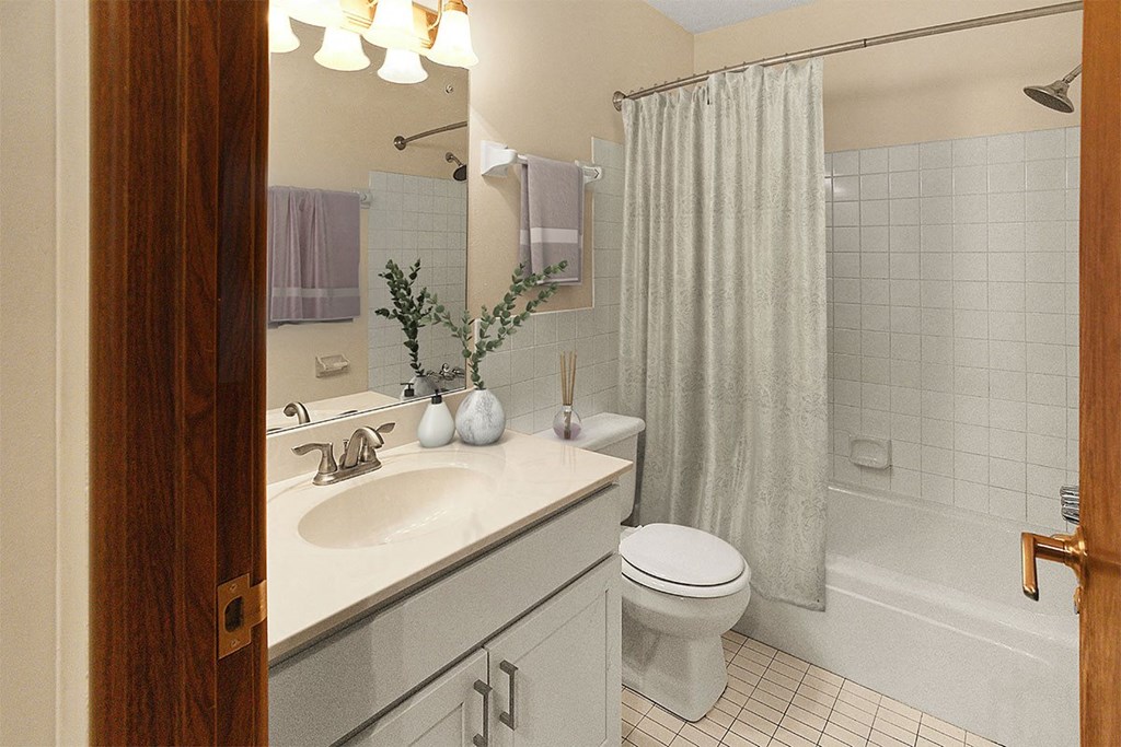 A bathroom with a white toilet, sink, and shower.
