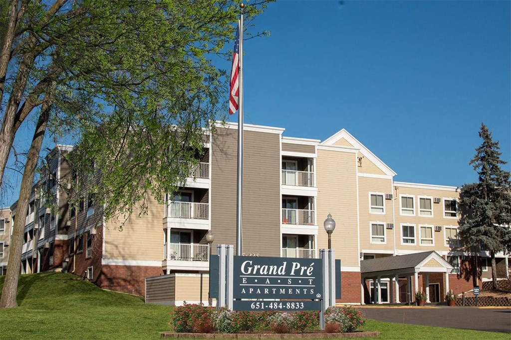 A building with a sign that says Grand Pré Apartments.