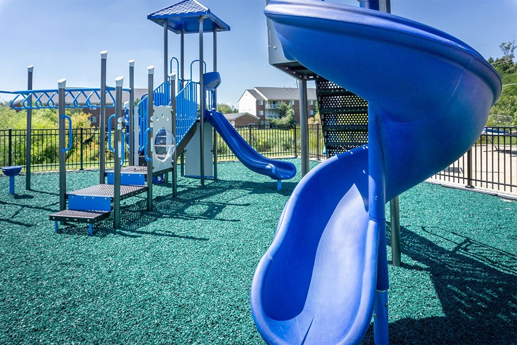 A blue slide in a playground.