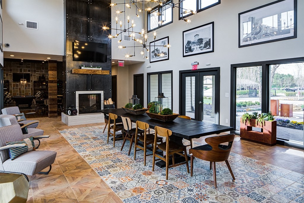 a large living room with a large dining table and a fireplace