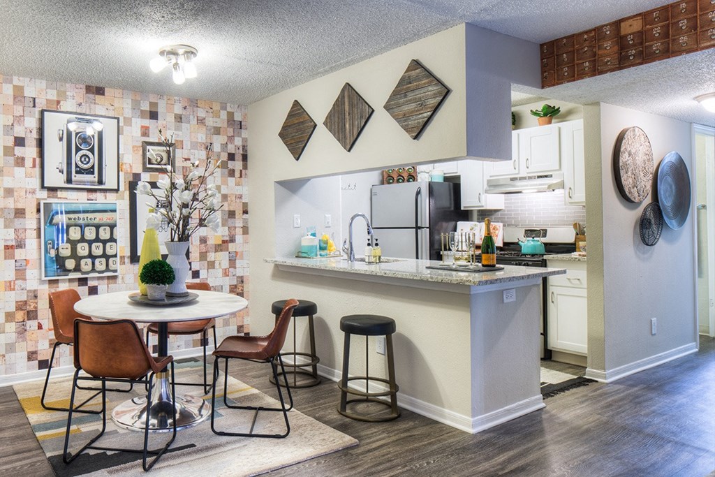an open kitchen and dining area with a table and chairs