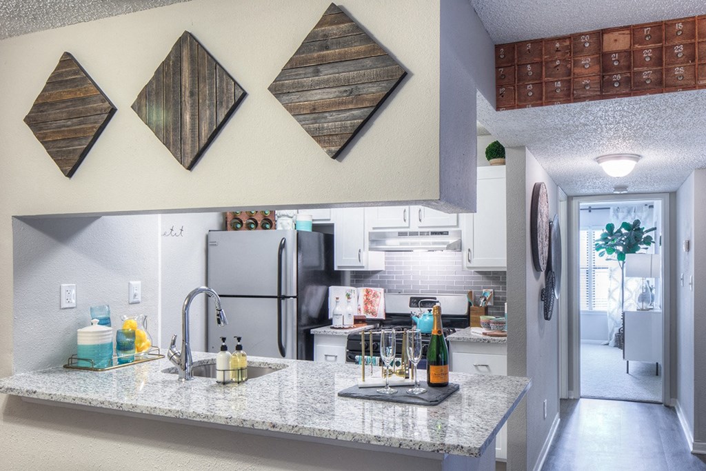 a kitchen with a granite counter top and a sink