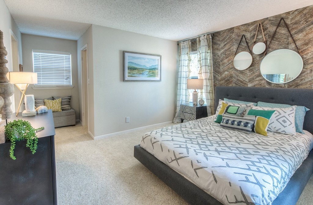 a bedroom with a bed and a dresser and a window