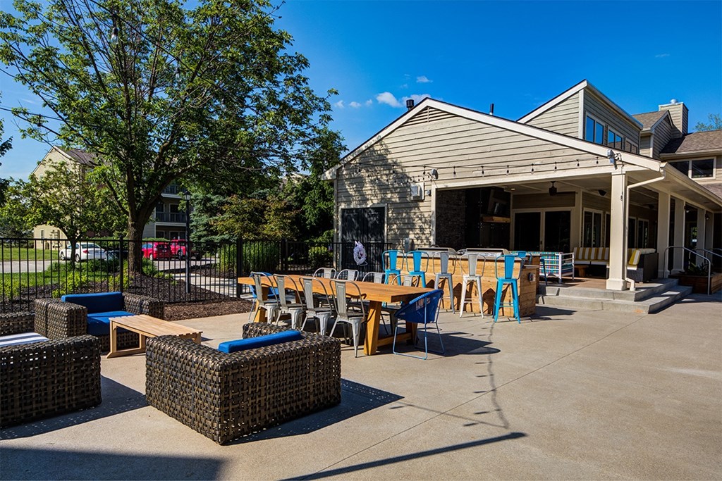 a patio with tables and chairs outside of a building