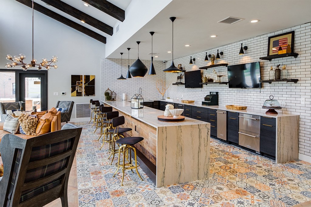 a kitchen and dining area with a bar and chairs and a television