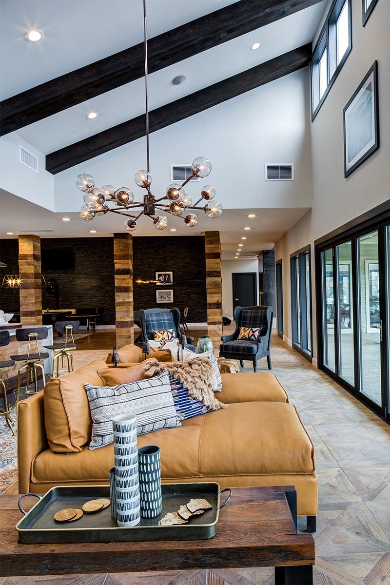 a large living room with a brown couch and a coffee table