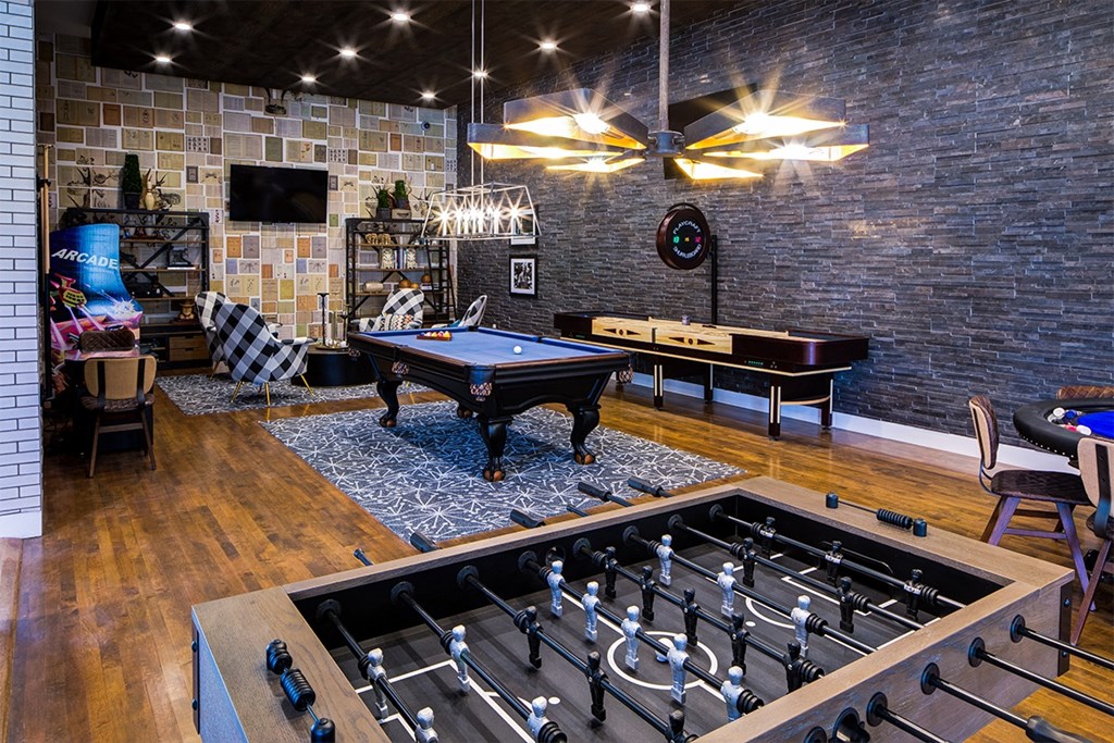 a game room with a pool table and foosball