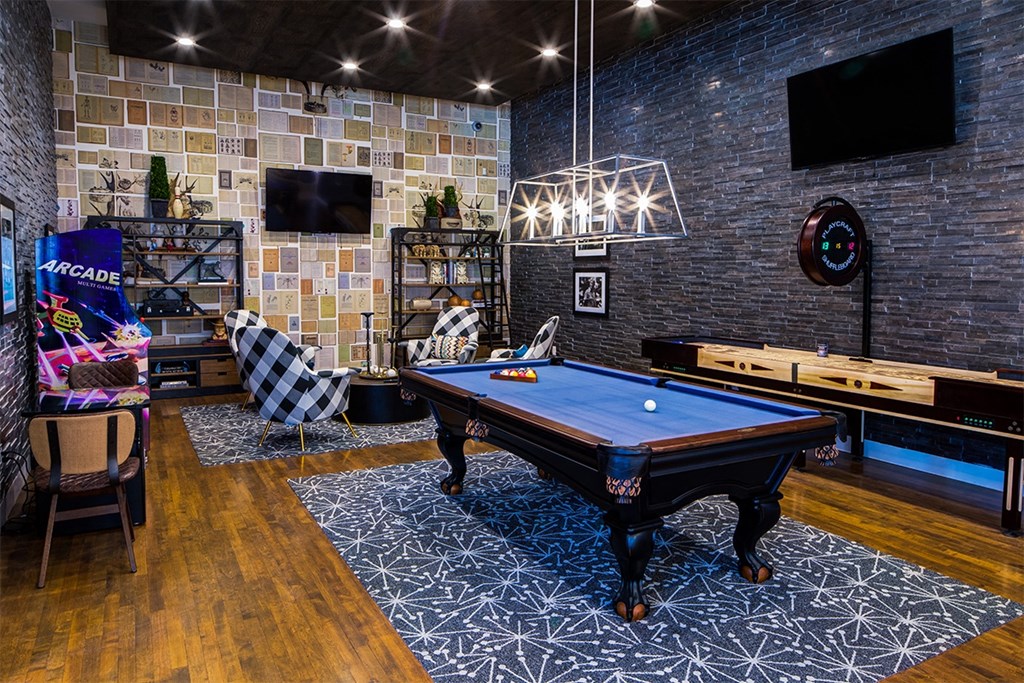 a game room with a pool table and a tv