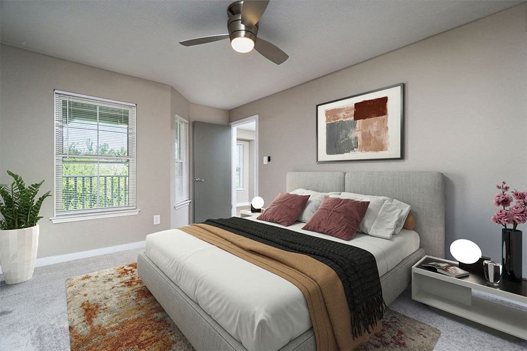 a bedroom with a bed and a ceiling fan