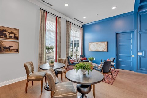 A dining room with a table set for six and a view of the city.