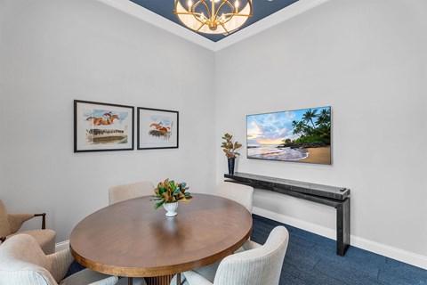 A dining room with a wooden table and chairs.